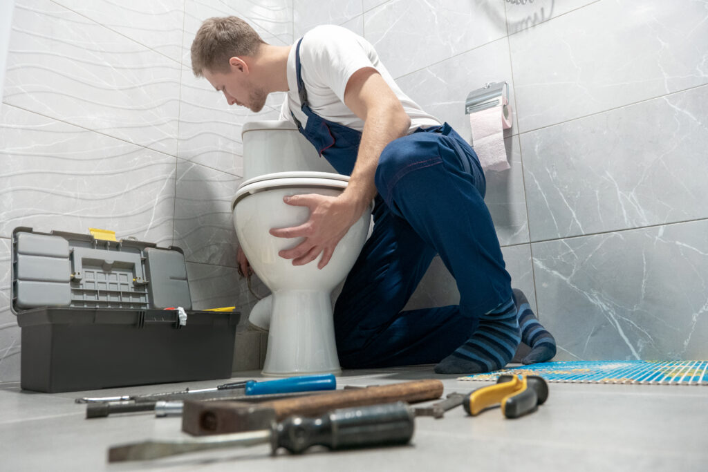 man repairing toilet